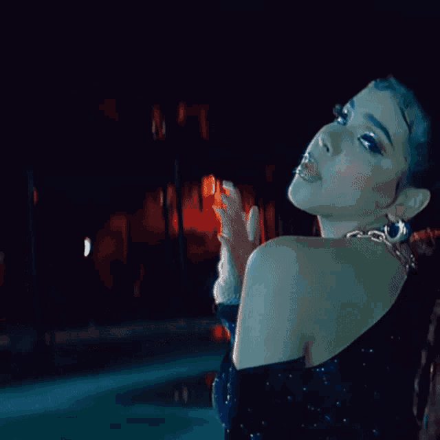 a woman with red hair is dancing in a dark room .