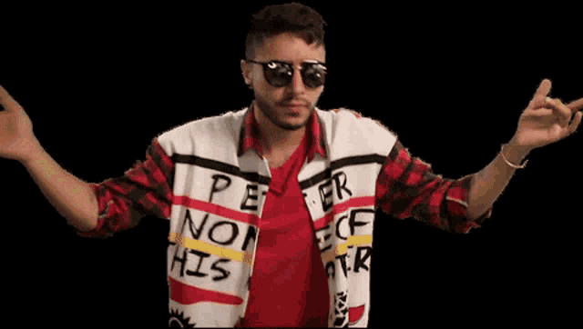 a man wearing sunglasses and a shirt that says peace non his