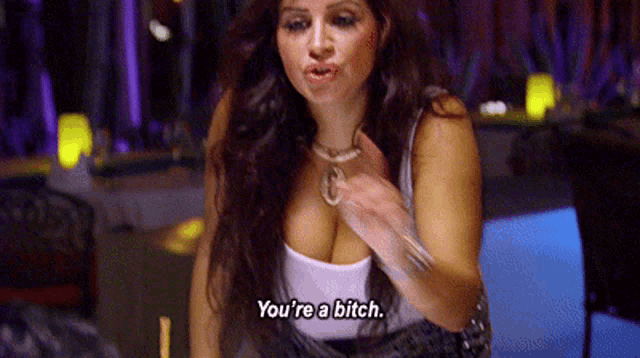 a woman in a white tank top is talking about being a bitch .