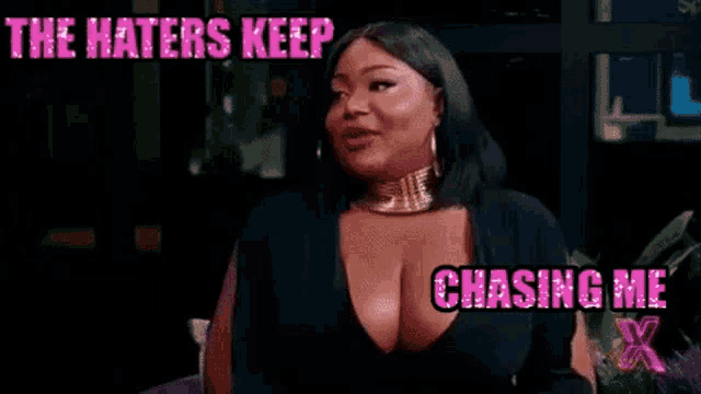a woman in a black dress is sitting on a couch and says `` the haters keep chasing me x '' .