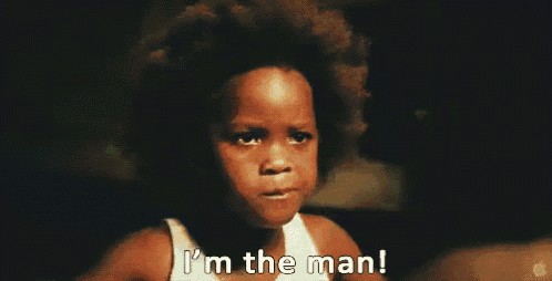 a young boy with an afro is screaming and saying i 'm the man