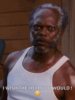 a man with a beard is wearing a white tank top and saying `` i wish the hell you would ! ''