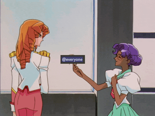 a woman holds up a sign that says @everyone