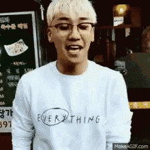 a man wearing glasses and a shirt that says everything on it