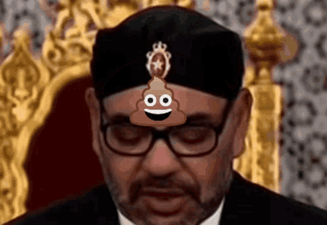 a man wearing glasses and a hat has a poop face on his forehead
