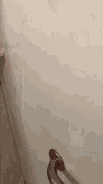 a close up of a door handle on a wall