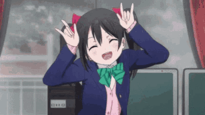 a young girl in a school uniform is making a peace sign with her hands .