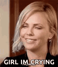 a woman is smiling with her eyes closed and the words `` girl i 'm crying '' written on her face .