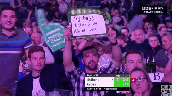 a man holds up a sign that says my boss thinks im still at work
