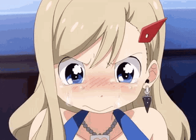 a girl with blonde hair and blue eyes is wearing a necklace that has a heart on it