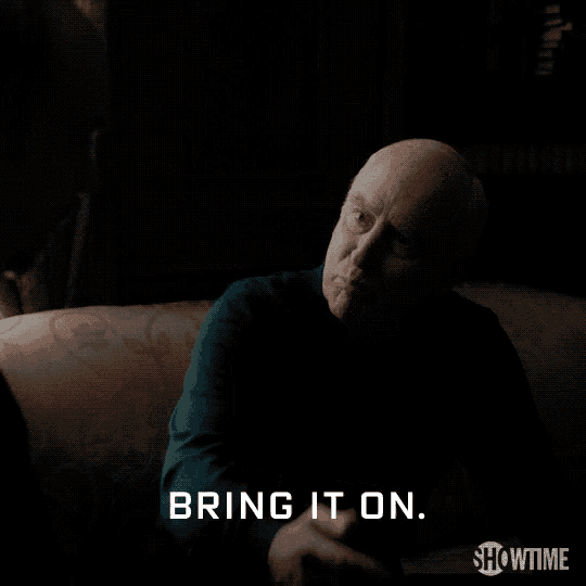 a man is sitting on a couch and says bring it on showtime