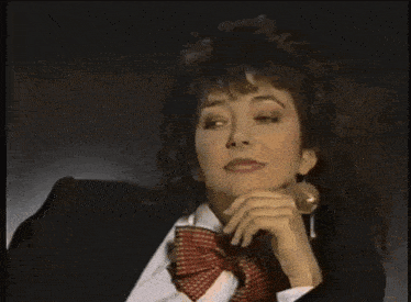 a woman in a tuxedo with a bow tie