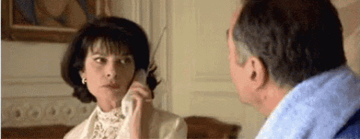 a man and a woman are talking on a cell phone .
