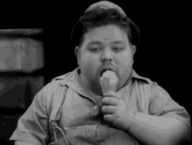 a fat man is eating an ice cream cone