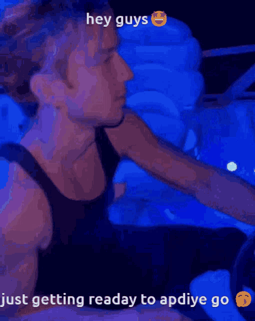 a man in a black tank top with the words hey guys just getting ready to apdiye go on the bottom