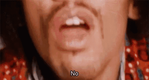 a close up of a man 's mouth with the words `` no '' written above it .