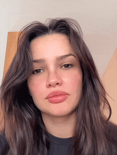 a close up of a woman 's face with a black shirt on