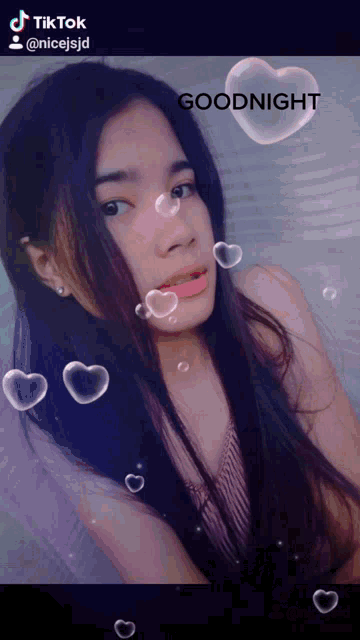 a girl with hearts around her and the words goodnight