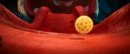 a close up of a person 's mouth with a yellow ball coming out of it .