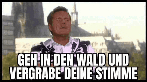 a man is standing in front of a building with a caption that says geh in den wald und vergrabe deine stimme