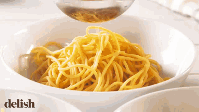 a bowl of noodles is being poured with the word ce above it