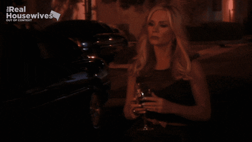 a woman is standing in front of a sign that says real housewives out of context