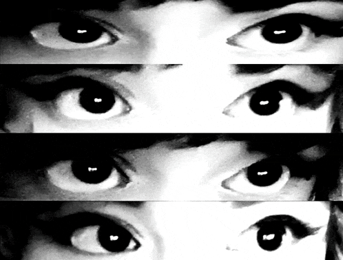 a black and white photo of a woman 's eyes looking at the camera