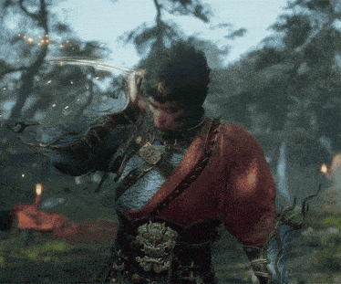 a monkey with a sword in his hand is standing in the woods