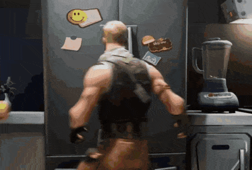 a man is standing in front of a refrigerator with a smiley face on the door