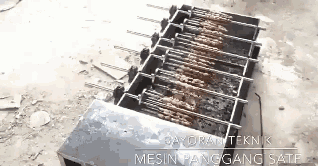 a bunch of meat is cooking on a grill with the words dayoran teknik mesin panggang sate written on the bottom