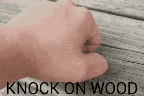a fist is shown with the words knock on wood above it