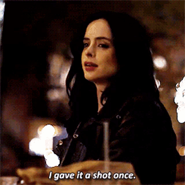 a woman in a leather jacket says i gave it a shot once while sitting at a table