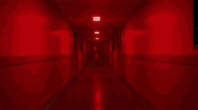 a woman in a mask is walking down a hallway in a hospital .