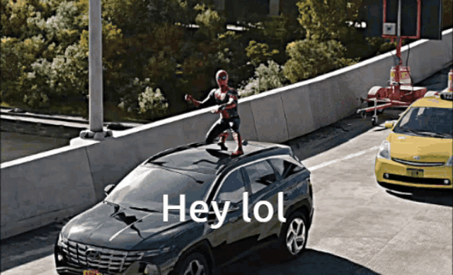 a spiderman figure is standing on top of a car with the words hey lol below it
