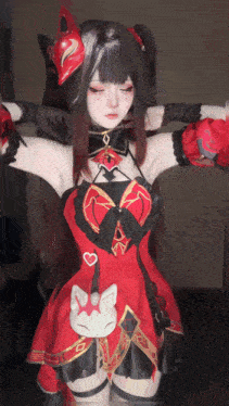 a woman in a red and black dress with a cat on the pocket