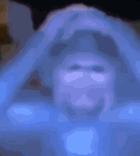 a blurred image of a person 's face with a black background