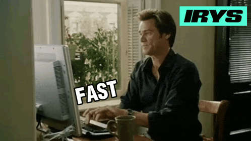a man sitting in front of a computer with the word fast written on the screen