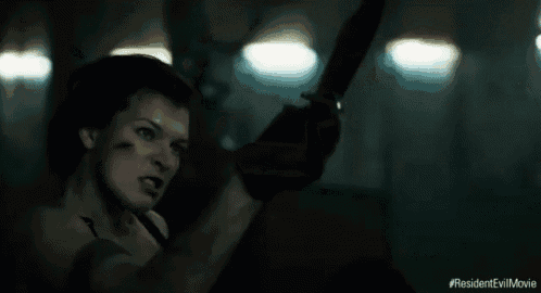 a close up of a woman in a dark room with the hashtag #resident evil movie