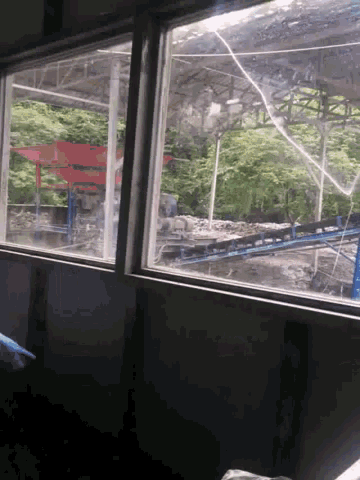a window with a view of a building and trees outside