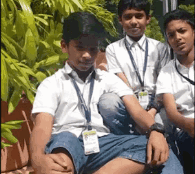 a group of young boys in school uniforms are posing for a picture