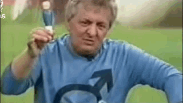 a man wearing a blue shirt with a male symbol on it