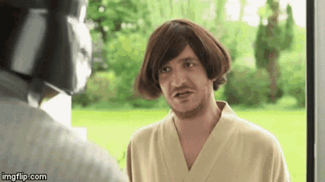 a man wearing a wig and a robe is talking to another man .