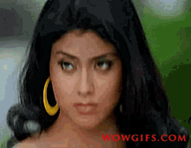 a close up of a woman 's face with wowgifs.com written in red