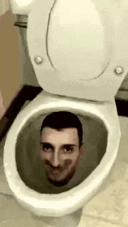 a man 's face is sticking out of a toilet bowl .