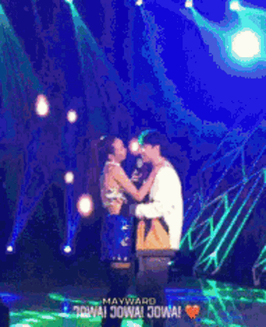 a man and a woman kissing on a stage with the words mayward jowa jowa jowa