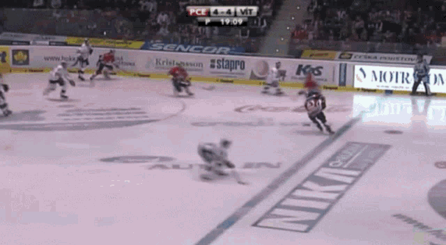 a hockey game is being played in a stadium sponsored by sencor and stapro