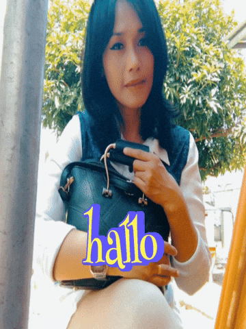 a woman is holding a black purse with the word hallo written on it