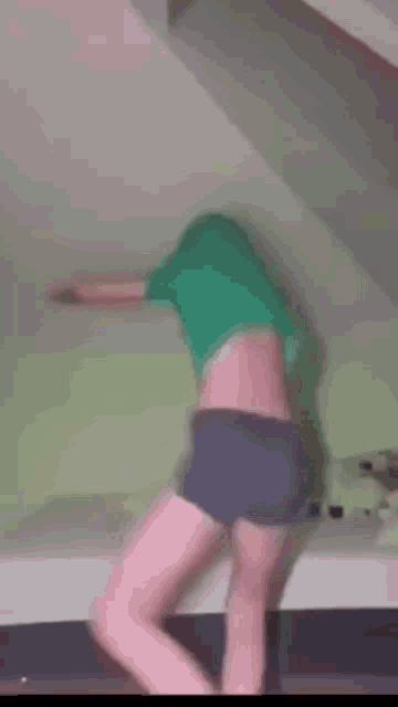 a person is standing on a bed with their head in the air .