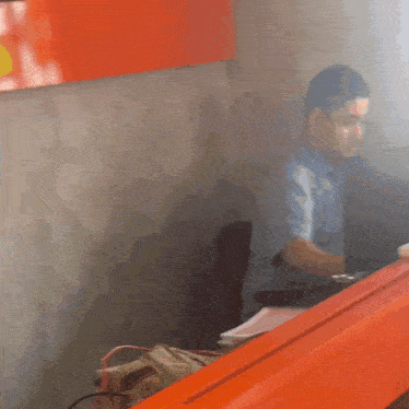 a blurry picture of a man sitting at a table