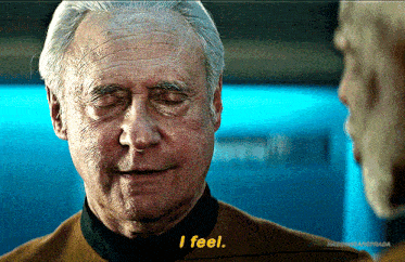 an older man with his eyes closed says " i feel " in front of another man
